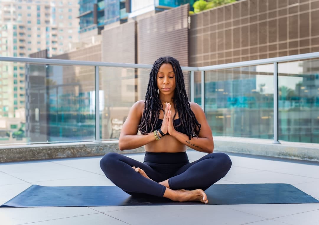 Woman meditating peacefully on a yoga mat