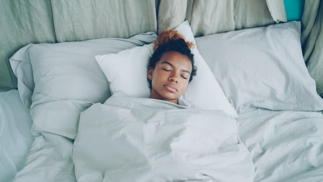 Woman sleeping peacefully in a comfortable bed
